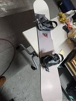 Full view of snowboard with bindings