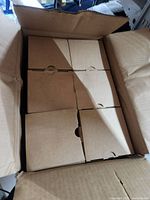 Master carton open showing six inner cardboard boxes