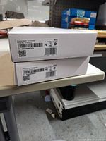 Two boxed ADT touchscreen panels stacked showing product labels