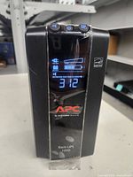 Front view showing APC Back-UPS 1000 with LCD display powered on