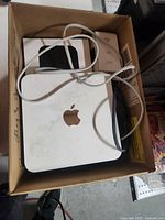 Overview of box showing Mac mini, Apple TV, AirPort Express and cable