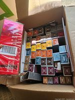 Open carton filled with many Kenra Color hair dye boxes showing assorted shade labels