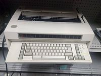 Front view showing full typewriter, keyboard, paper feed area