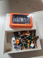 Overall view showing sealed Lionel pack and box of loose figures