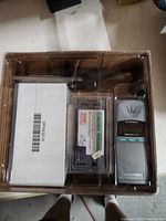 Entire open box showing phone, battery, manual and cord