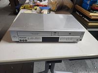 Front view of Panasonic VCR/DVD combo showing both media slots and overall condition