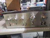 Front view of Pioneer SA-5800II amplifier showing controls and illuminated power indicator