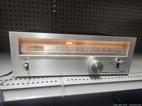 Front view showing full tuner face, power indicator illuminated