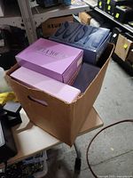 Cardboard box containing multiple wig boxes