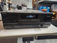 Front view of Technics SU-G75 amplifier showing display, knobs and buttons