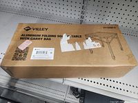 Sealed box labeled Villey Aluminum Folding Square Table with carry bag, model VY1330B/A