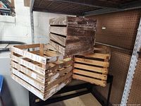 Three crates stacked showing natural, painted, and dark stained finishes