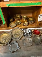 Group shot showing all ashtrays on shelf and floor