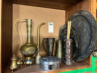 Shelf view showing ewer, vases, incense holder, pewter tin and nested chargers