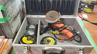 Open case showing grinder, extra wheels, accessories