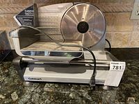 Front view of Cuisinart food slicer showing blade, food carriage and power cord