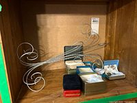 Stand resting in shelf with four jewelry boxes