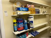 Shelved items overview: cotton swabs, tissues, cleaners, LED bulbs