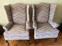 Front view of both armchairs showing upholstery pattern and legs