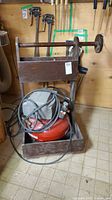 Complete compressor on wooden rolling stand with hose