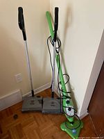 Group view: two Shark sweepers and one H2O Mop X5 steam mop