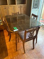 table and two chairs overview showing glass top and turned legs