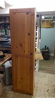 Full front view of tall pine cabinet