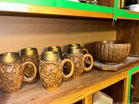 Set showing six mugs, carved bowl, tray