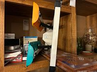 Shelf view showing cribbage board, several Bicycle card decks, stepper partially stored