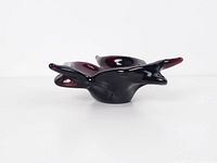 Side view of freeform amethyst purple art glass bowl