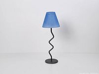 Full view of metal zigzag votive candle holder with blue glass shade