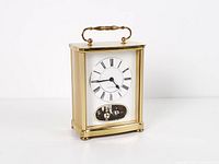 Full front and partial side view of brass carriage clock