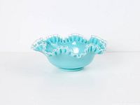 Full view of turquoise ruffled glass bowl