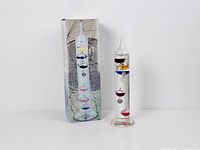 Thermometer standing beside original box