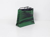 Front angled view showing overall bag shape, green glaze, and handles