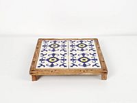 Square wooden tray on feet showing tile surface pattern