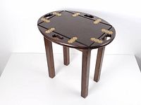 Tray table with sides lowered showing oval top and legs