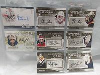 Sheet showing all eight autographed hockey cards in pockets