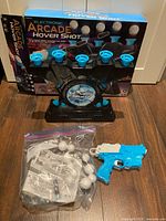 Full set showing target base, blaster, foam balls bag and box