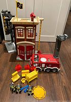 Front view of fire station, fire truck, loose accessories arrayed