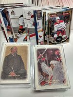 Front view showing sleeved Upper Deck Lord Stanley and Mario Lemieux cards with stacks of assorted SP Authentic and O-Pee-Chee cards behind