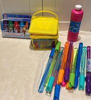 Full lot showing snow marker box, chalk bucket with handle, bubble solution bottle, 12 bubble wands