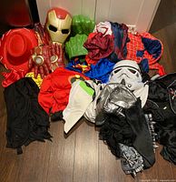 Overall pile of costume pieces showing masks, fists, hats, fabrics