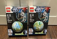 Front of two sealed LEGO 9679 AT-ST & Endor boxes