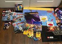 Full lot overview showing polybags, blind bags, keychains, posters and gift bag