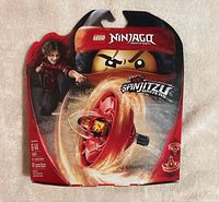 Front of sealed LEGO Ninjago 70633 Kai spinner set showing age, piece count, and graphics