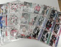 Spread of hockey goalie cards in clear sleeves