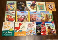 All fourteen children’s books laid out on floor showing front covers