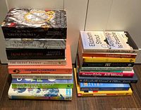 Two stacks of 17 assorted books showing spines