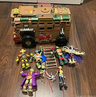 Overall lot showing Shellraiser vehicle, six figures, ladder and weapons